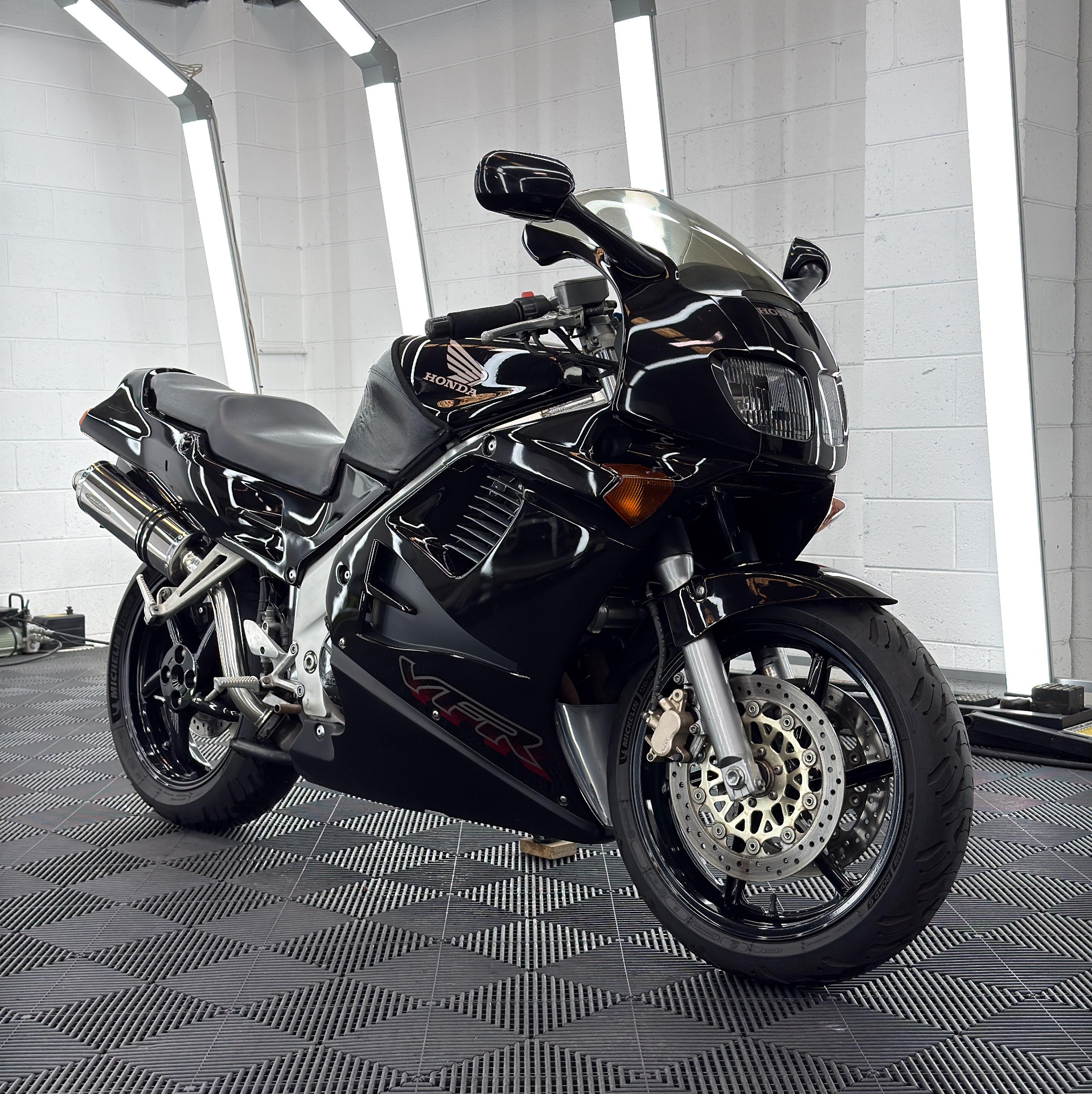 Black Honda VFR in the detailing studio before Stage 1 paint enhancement