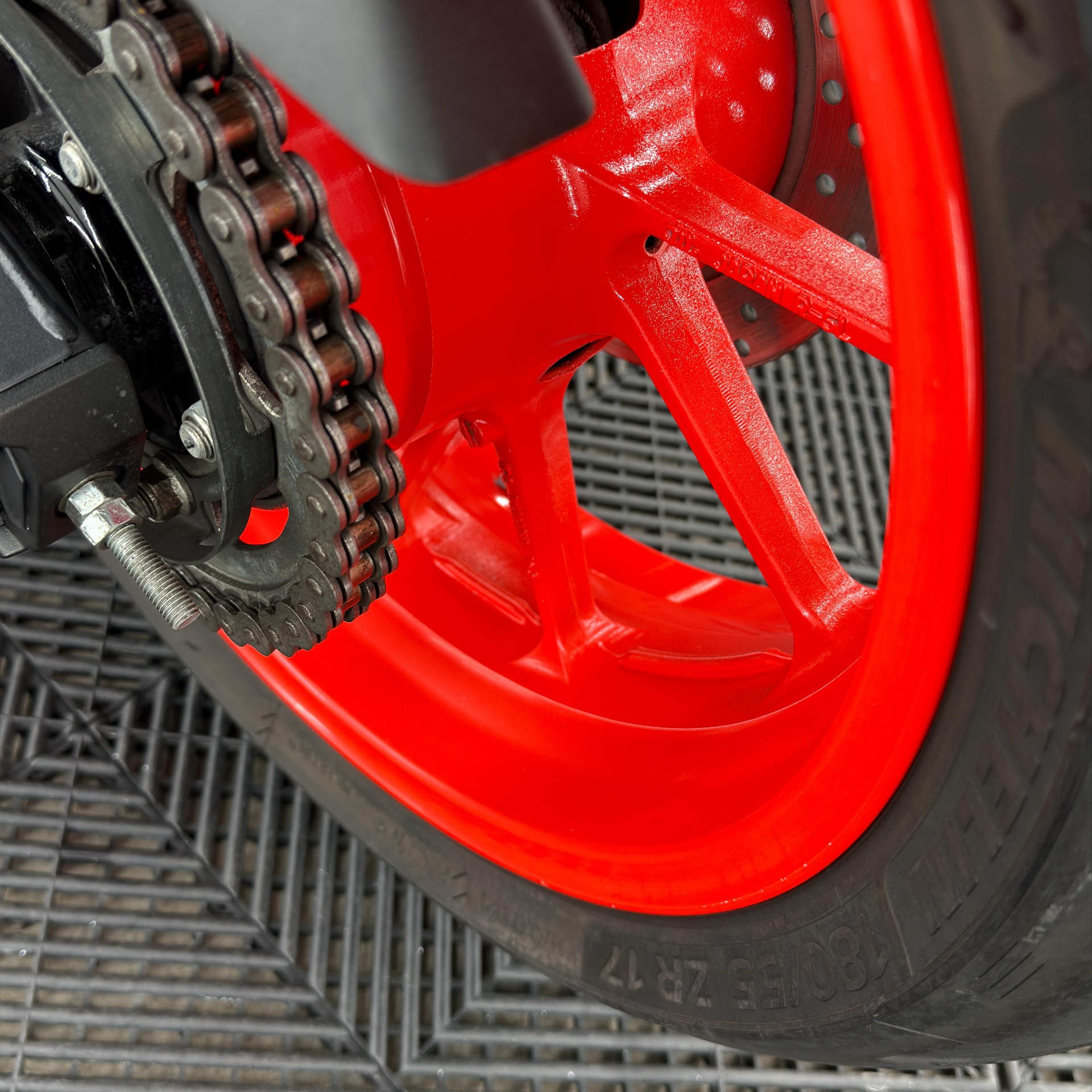 Red motorcycle wheel and chain detail