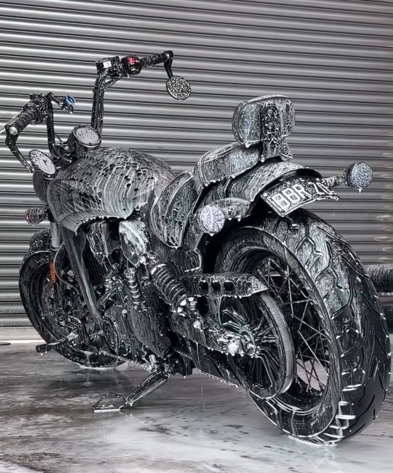 Motorcycle covered in snow foam during safe wash